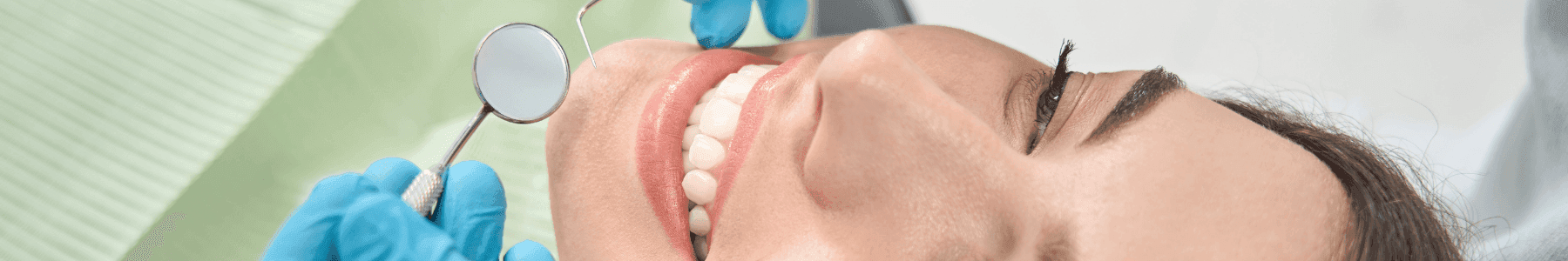 Dentist holding a ceramic dental crown.
